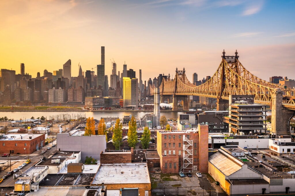 Queensboro Bridge in Queens, NY with a sunset in the background